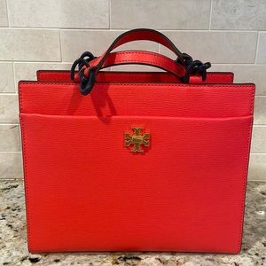 Tory Burch orange leather handbag with resin chain and leather handles.